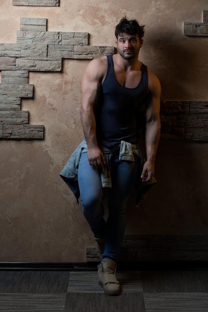 Model Flexing Muscles Against a Brick Wall