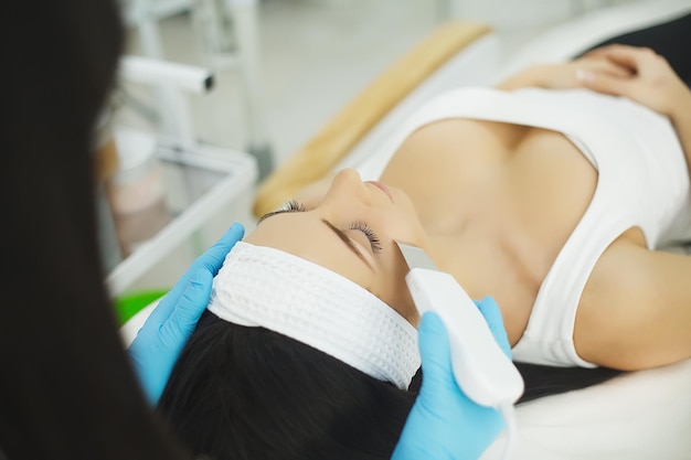 Model getting lifting therapy massage in a beauty SPA salon