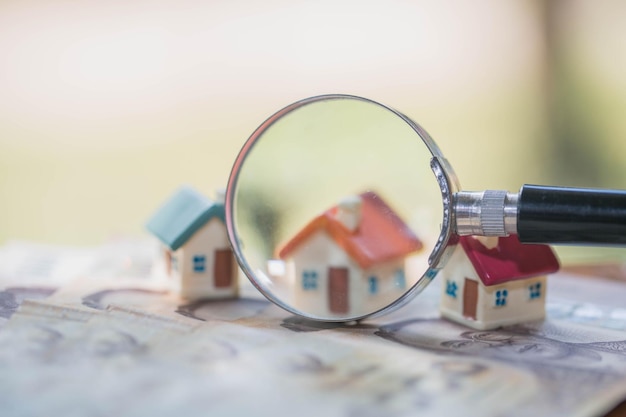 model house on banknotes saving money for real estate concept house model for pay loan