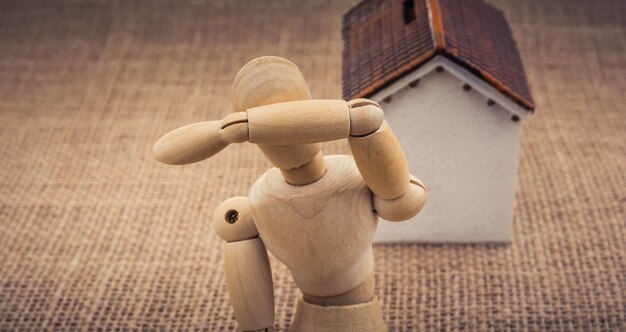 Model house and a man figure on a canvas