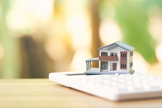 A model house model is placed on a calculator