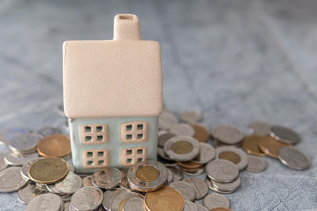 Model House with stack of coins House financing mortgage concept