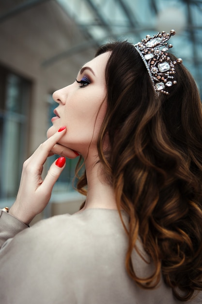 Model is posing with a crown on her head