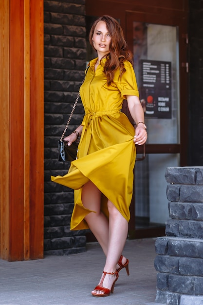 Model in a light yellow dress on the street