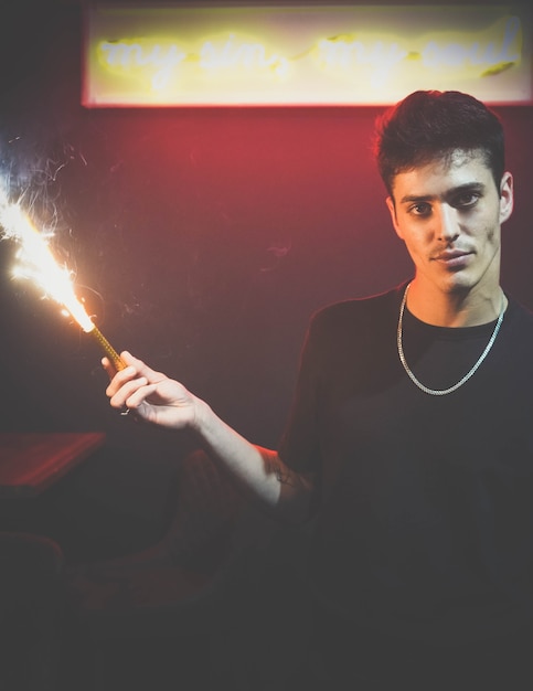 Model man holding a sparkler