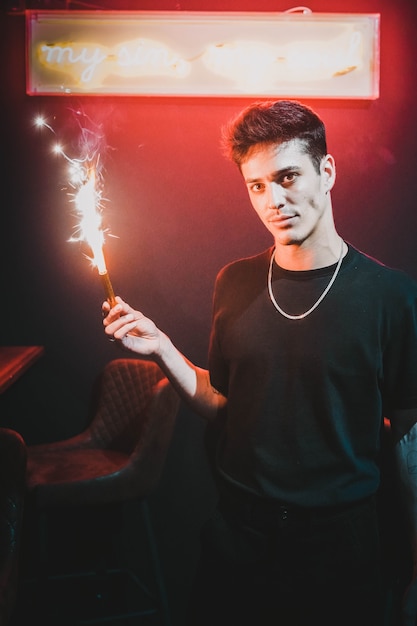 Model man holding a sparkler