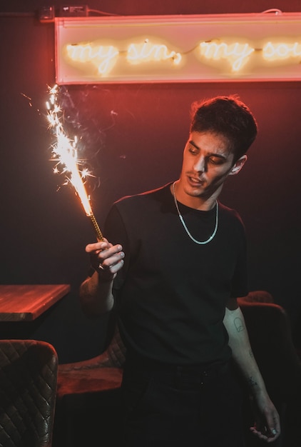 Model man holding a sparkler