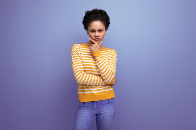 Model pensive latina young lady with afro hair on studio background