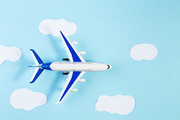 Model plane, airplane on blue pastel color background. Summer travel or vacation concept. Flat lay of miniature toy airplane. trendy minimal style, copy space