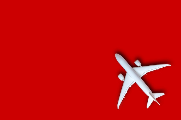 Model plane, airplane on red color background with copy space