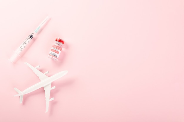 Model plane and COVID19 coronavirus vaccine vials bottles for vaccination buy vaccine