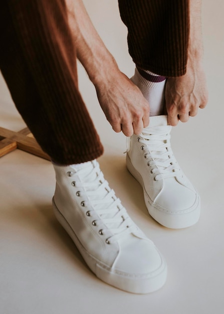 Model putting on sneaker studio shoot