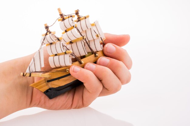 model sailboat in hand