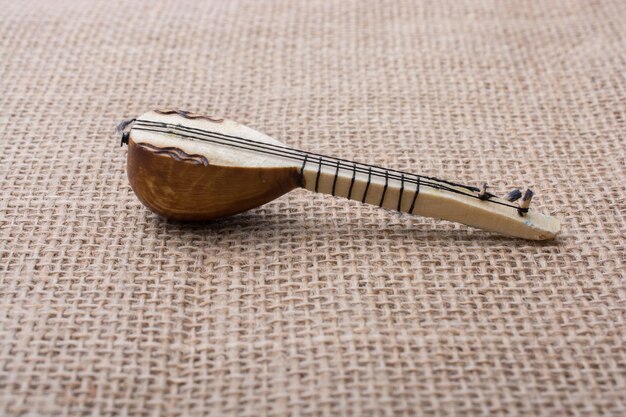 Photo model of turkish musical instrument saz on a linen canvas