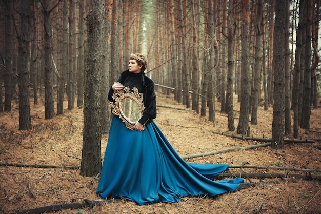 Model wearing blue skirt is posing as a queen