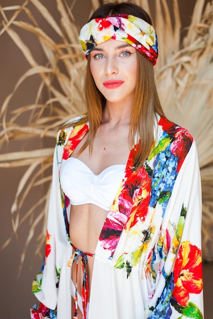 A model wears a colorful kimono with a floral pattern on the front.