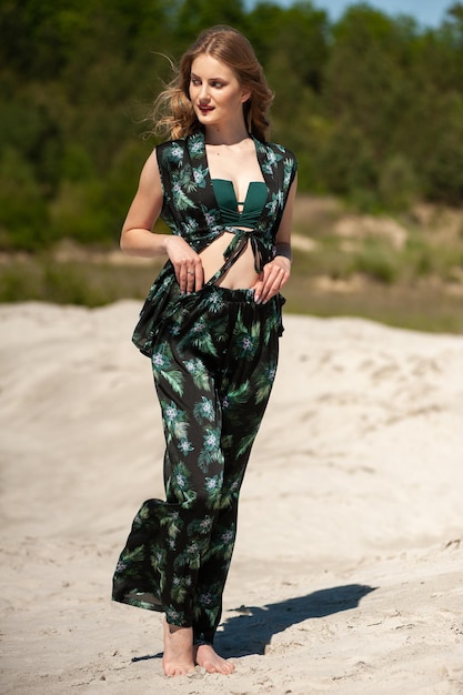 Photo a model wears a green and black top with a green pattern and a black top with a green and blue print.