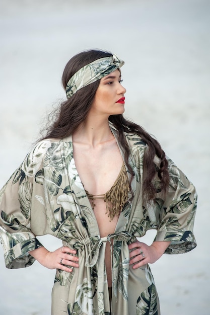 A model wears a green and white outfit with a red headband and a red headband.