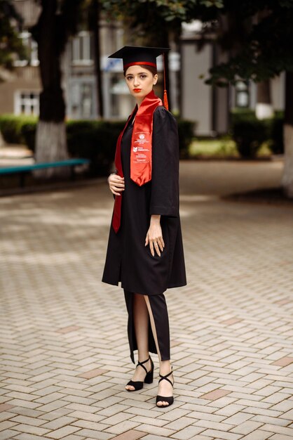 a model wears a red and black coat and a red cape