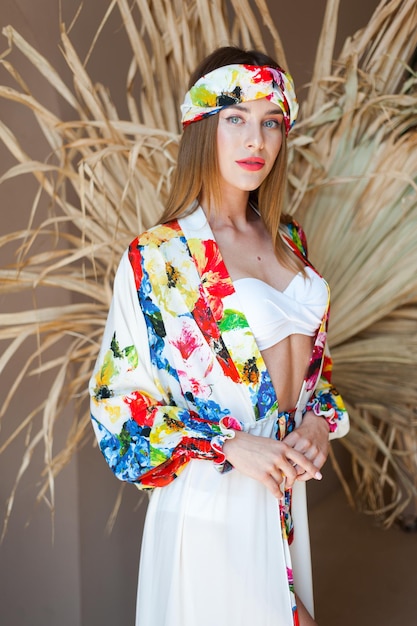 A model wears a white kimono with a red flower print