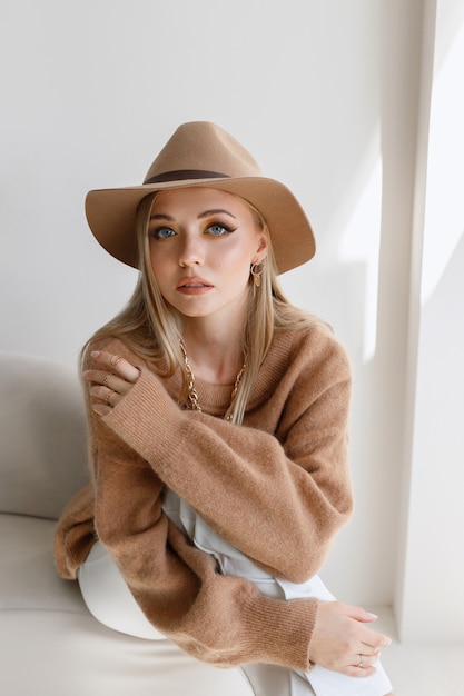 Photo model with autumn makeup in stylish clothes in the studio. close-up