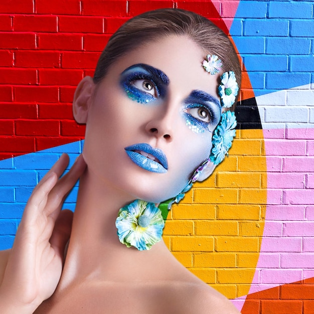 model with blue makeup flowers and background