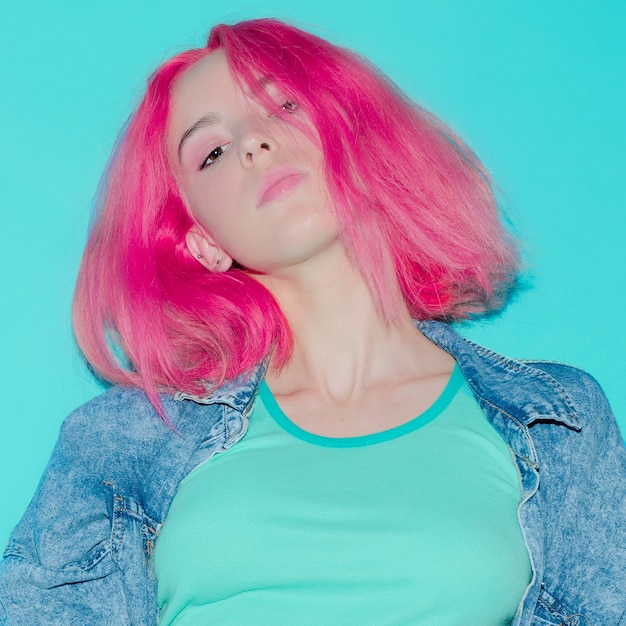 Model  with pink hair and denim clothing. Stylish look