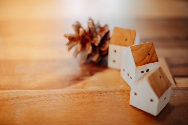 Model of a wooden house arranged with pine cones