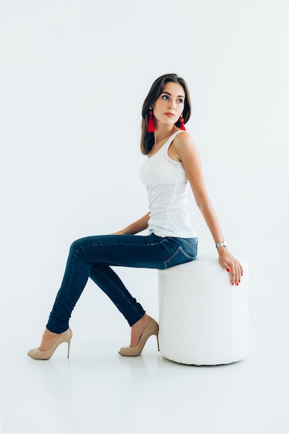 Model young girl in a white Tshirt and blue jeans