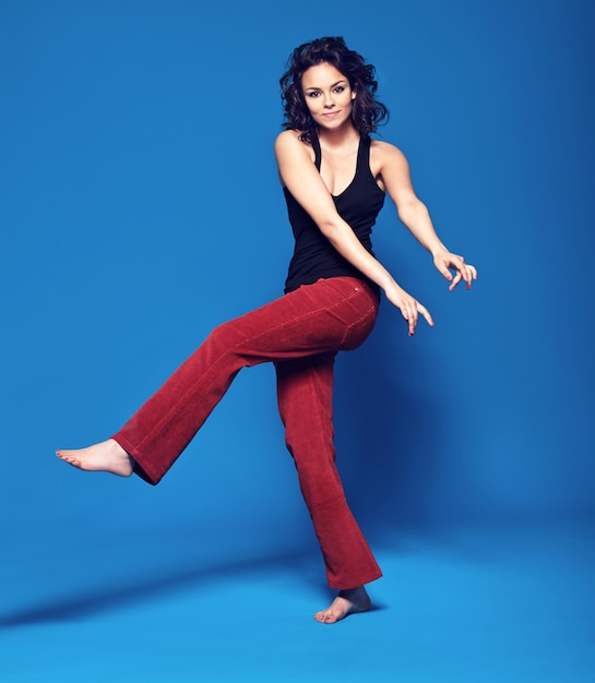 Modeling your clothes with confidence Studio portrait of a fashionable young woman posing against a blue background