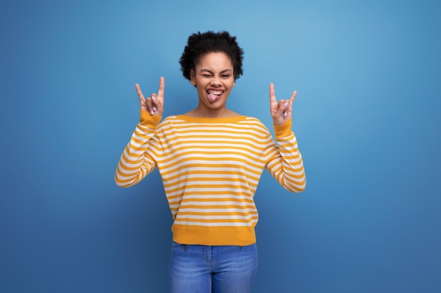 Models latina young lady with afro curls with grimace