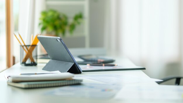 Moder workplace with computer coffee cup books and office supplies on white table