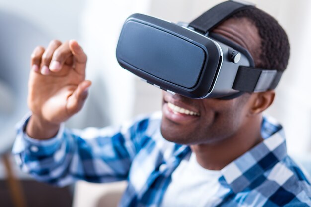 Modern 3d glasses being in use by a cheerful delighted young man while testing new technologies