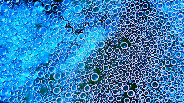 Photo modern abstract colorful drops on the surface of transparent plastic smooth small bubbles in the shape of a regular circle abstract background of water bubbles