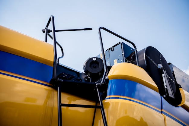 Photo modern agricultural machinery and equipment. yellow agricultural harvester.