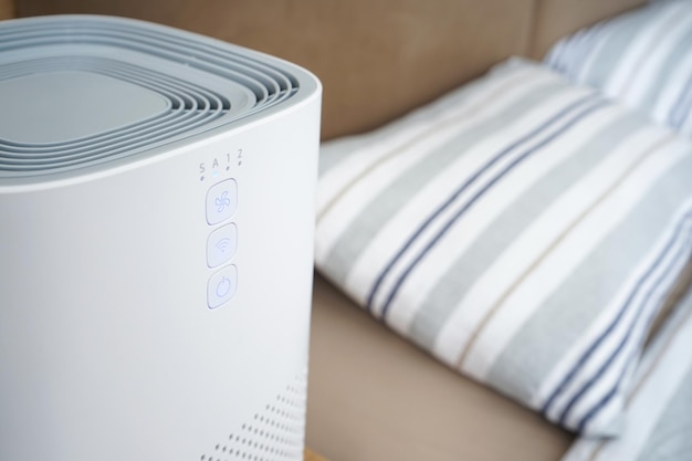 Modern air purifier in the bedroom by the bed, close-up.