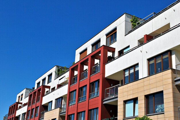 Modern apartment building on a sunny day with a blue sky facade of a modern apartment building