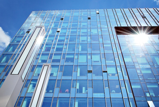 Modern architecture with sun ray glass facade on a bright sunny day