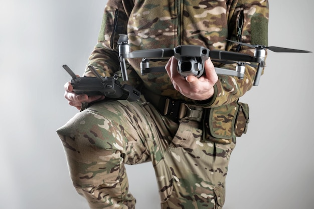Foto soldato dell'esercito moderno con telecomando e drone si prepara a volare ruolo cruciale dei droni nella guerra intelligente sorveglianza strategica attacchi di precisione e raccolta di informazioni