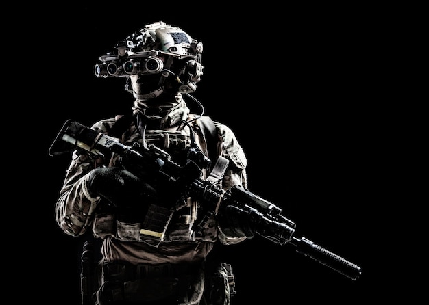 Modern army special forces equipped soldier, anti terrorist\
squad fighter, elite mercenary armed assault rifle, standing in\
darkness with night vision goggles on helmet, studio portrait,\
copyspace