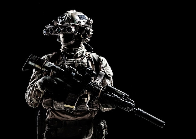 Modern army special forces equipped soldier, anti terrorist
squad fighter, elite mercenary armed assault rifle, standing in
darkness with night vision goggles on helmet, studio portrait,
copyspace