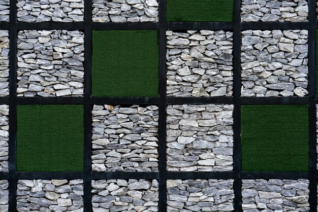 Modern Artificial grass and Stone wall background.