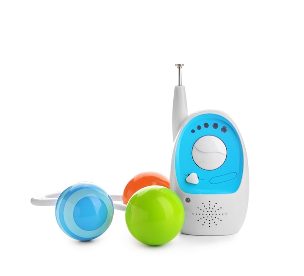 Modern baby monitor with toy on white surface