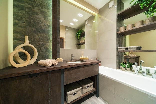 Modern bathroom decorated in eco style  with wooden furniture and green plants