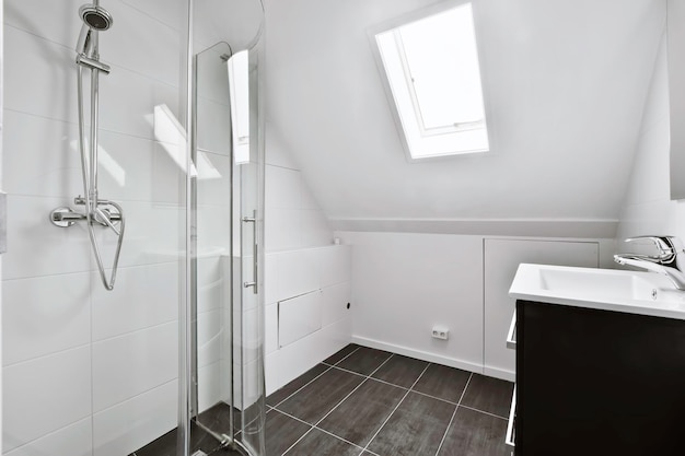 Modern bathroom design with black tiled floor and white walls and window