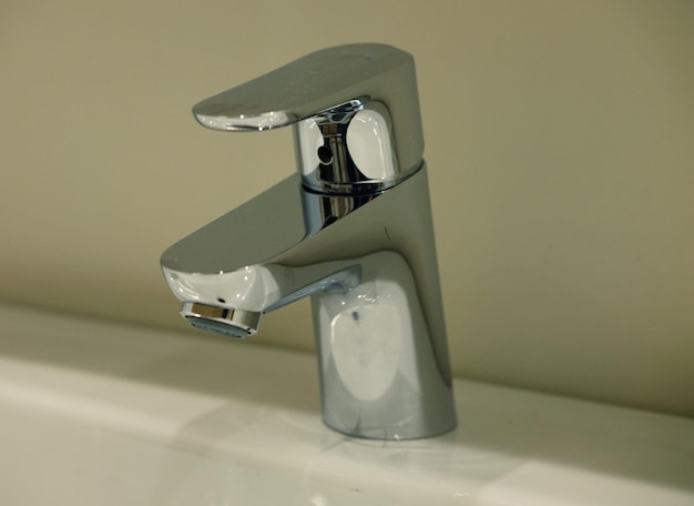 Modern bathroom faucet close up pictrure warn tones