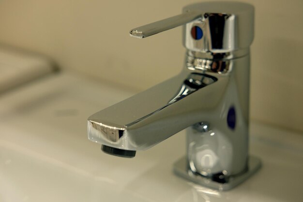 Modern bathroom faucet close up picture warm tones