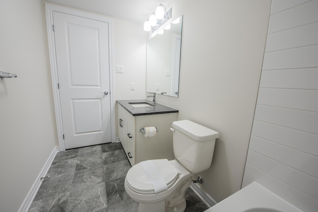 Photo modern bathroom interior with white vanity topped with gray countertop