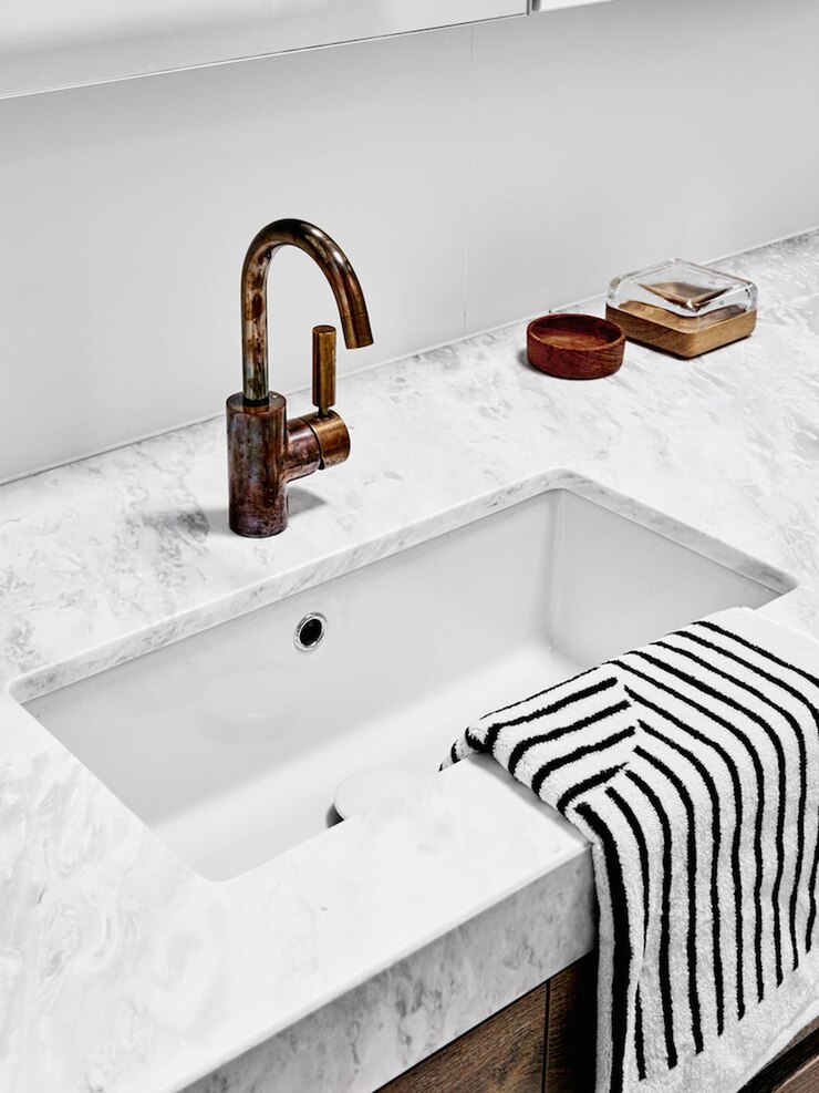 Photo modern bathroom sink with brass faucet