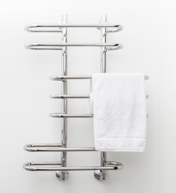 Modern bathroom towel dryer on white wall background